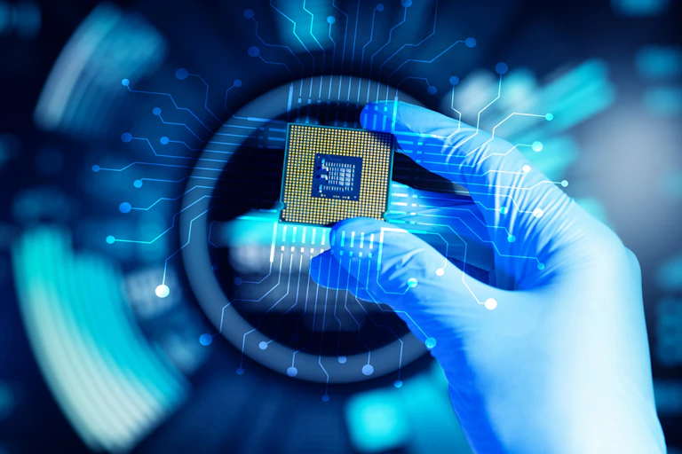 Hand holding up a semiconductor