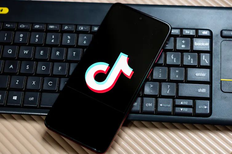 A phone screen displaying the TikTok symbol.