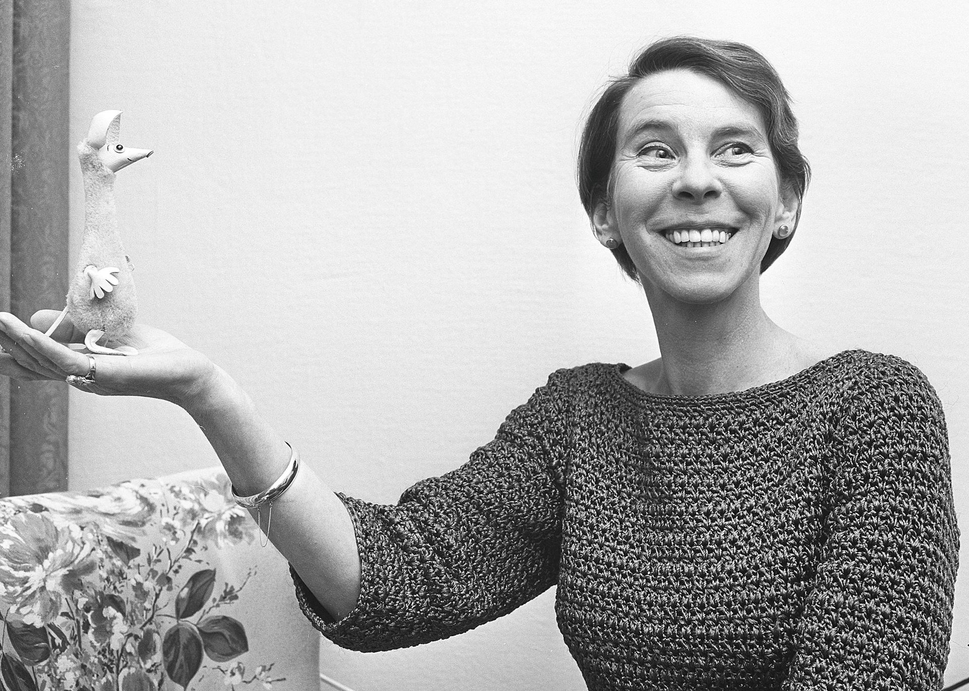 Tove Jansson holds a model of Sniff, who looks like a kangaroo.