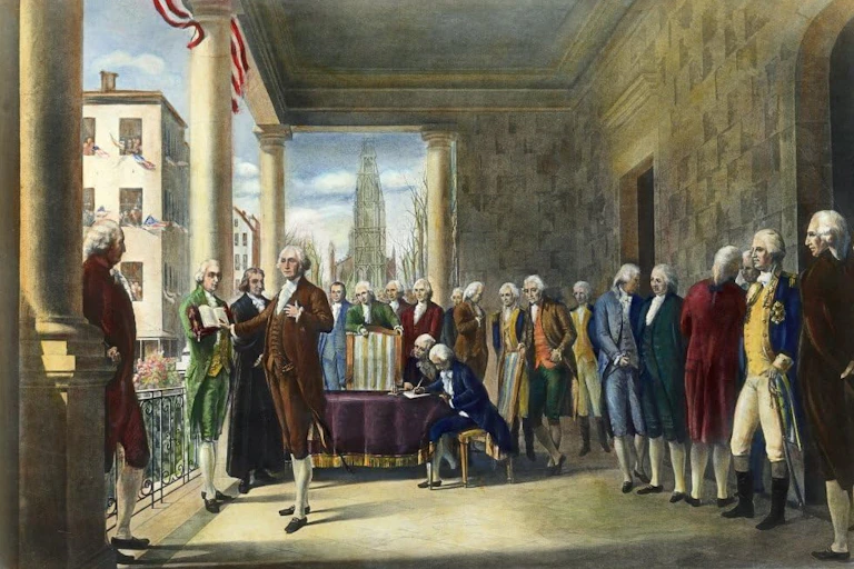 A man in a brown coat, waistcoat and breeches putting one hand on his heart while standing among several other men, who are looking at him.