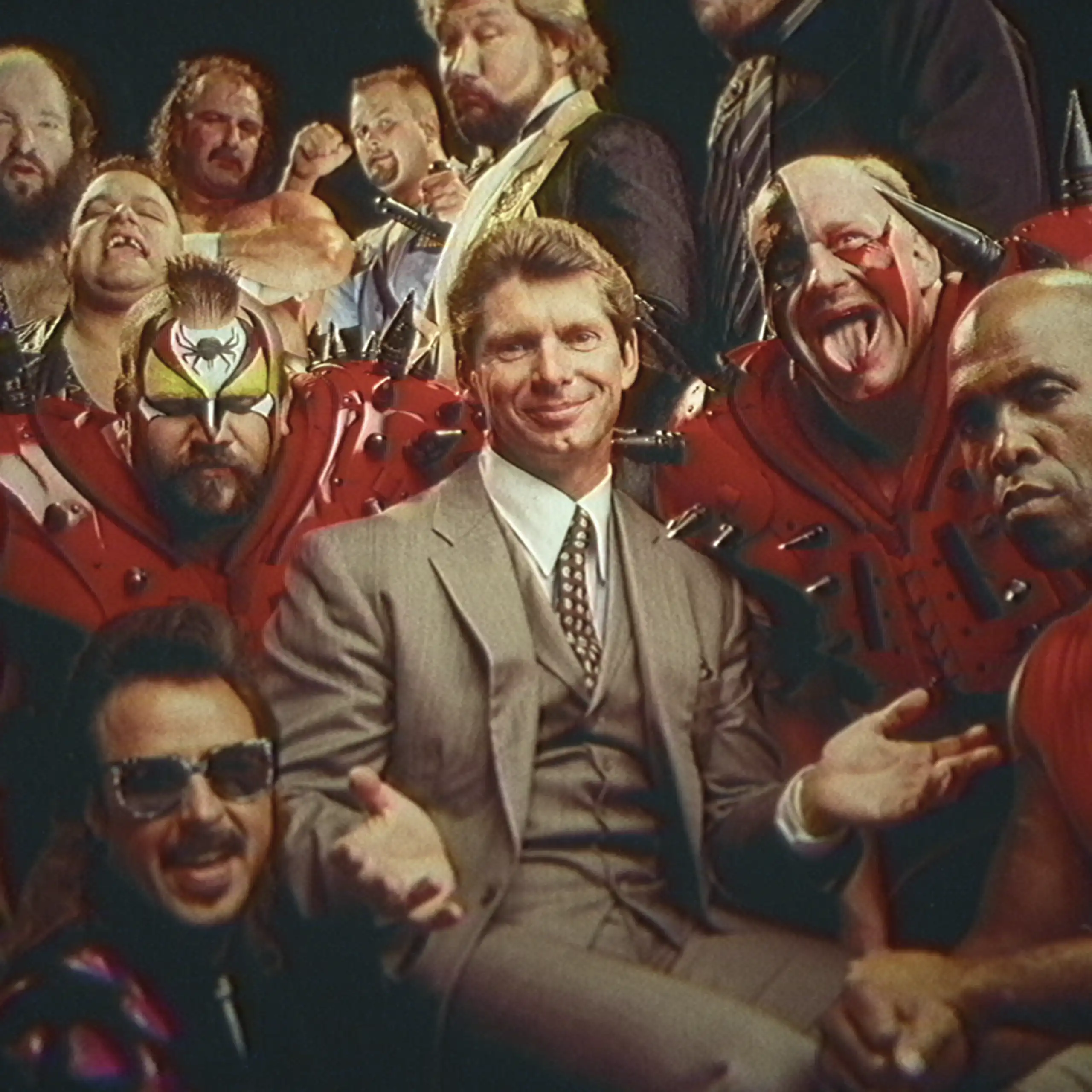 Vince McMahon in a suit surrounded by wrestlers