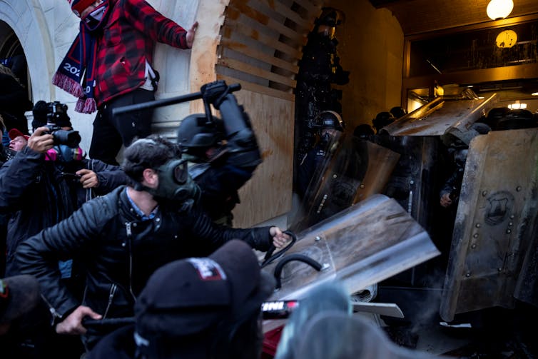 Armed mob bursts through a door