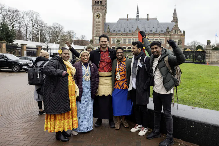 Representatives from Pacific island states gather outside the International Court of Justice