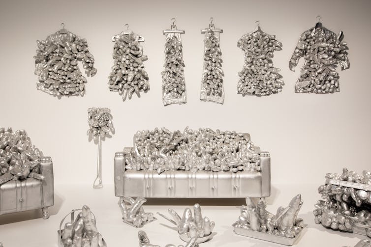 A lounge covered in silver phalluses.