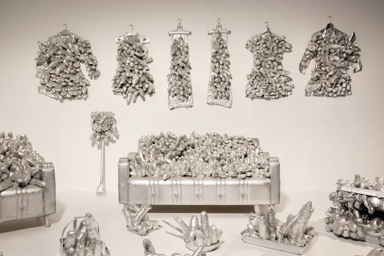 A lounge covered in silver phalluses.