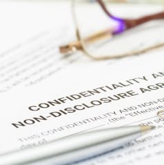 Blue pen on a confidentiality and non-disclosure agreement form