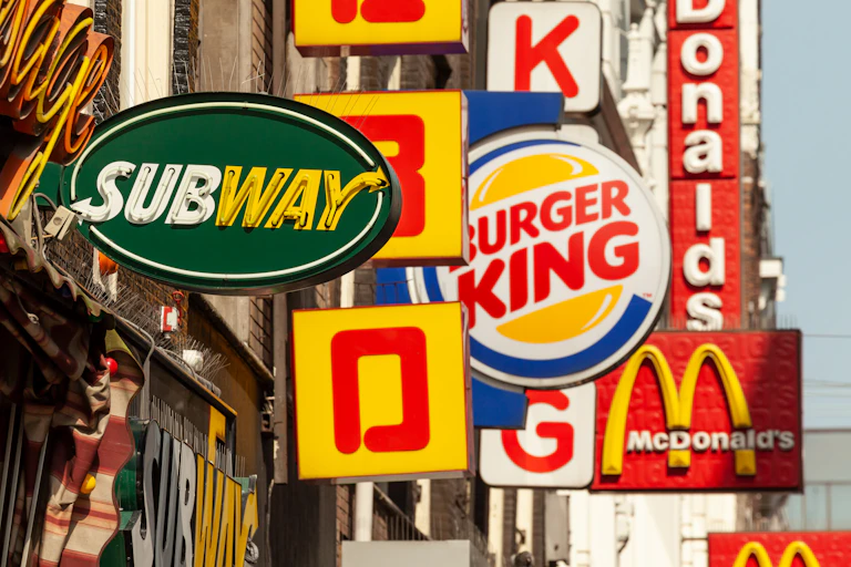 Signs of several fast food chains, notably Subway, Burger King and McDonalds