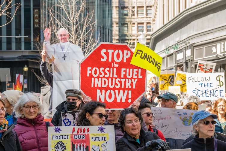 climate protestors with signs
