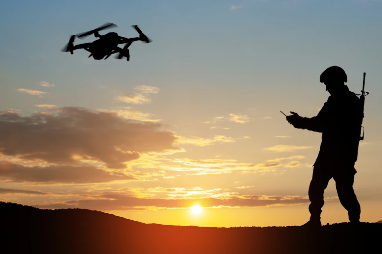 Silhouette of a soldier controlling a drone