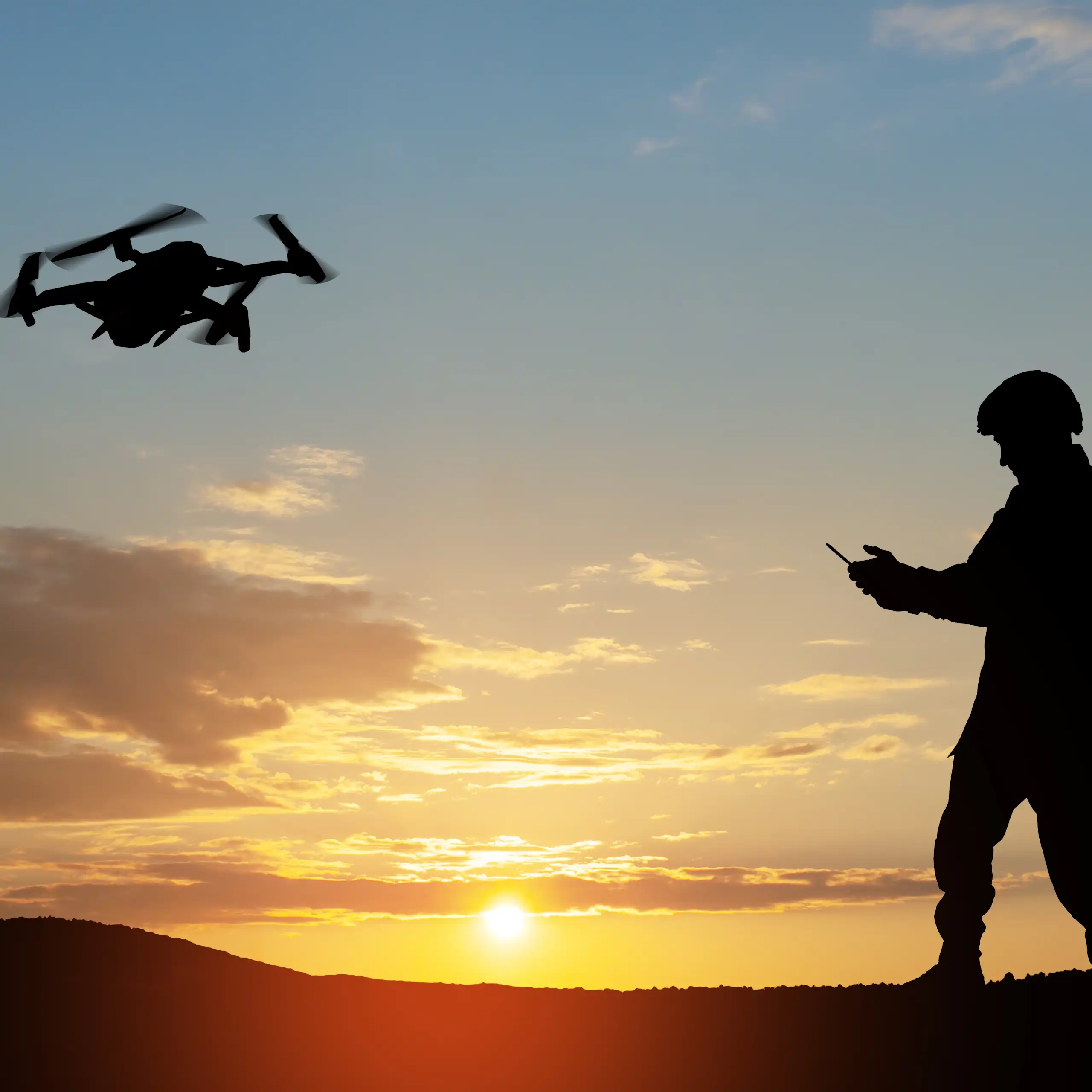 Silhouette of a soldier controlling a drone