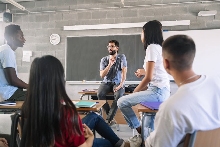 Teacher and students having discussion in class.