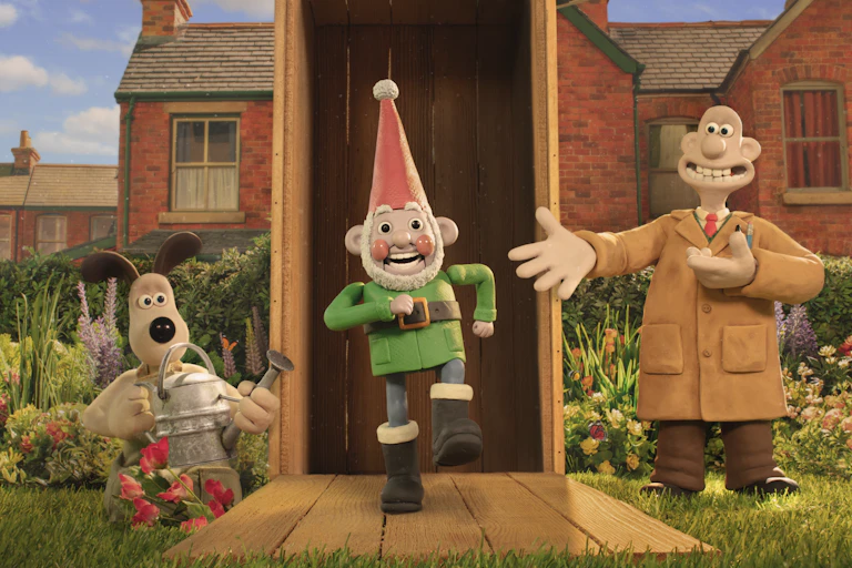 Gromit holding a watering can and Wallace presenting a garden gnome