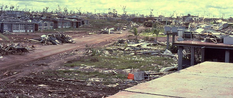 a streetscape of damaged buildings and debris