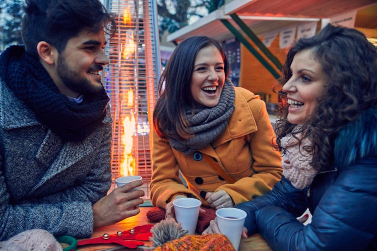 Adults socializing outdoors.
