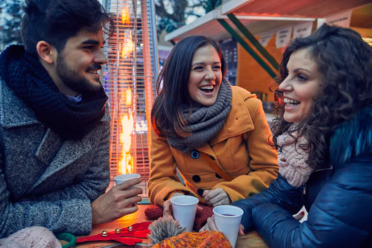 Adults socializing outdoors.