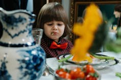 A child frowns at food.