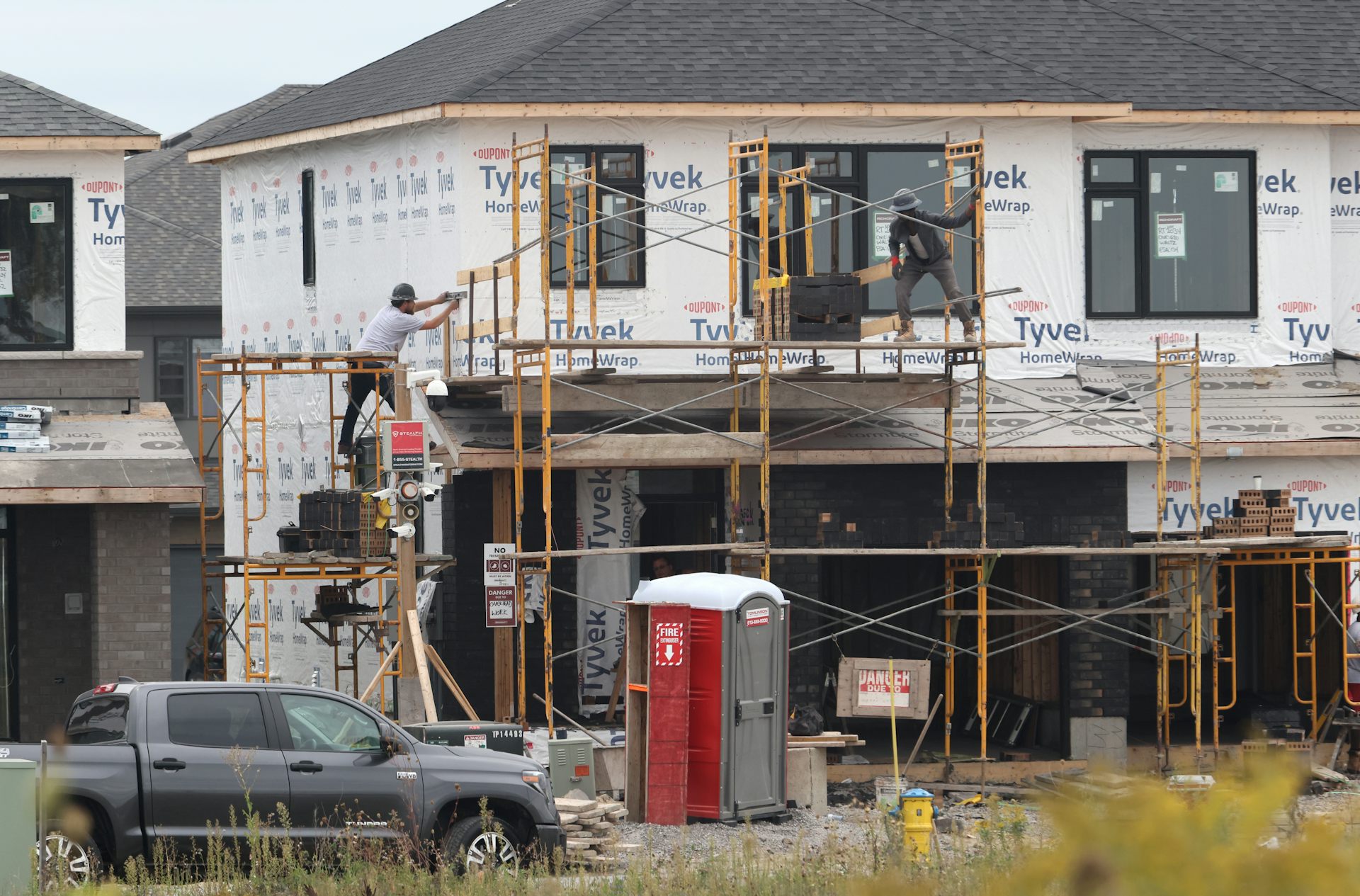 Construction workers working on a new detached house