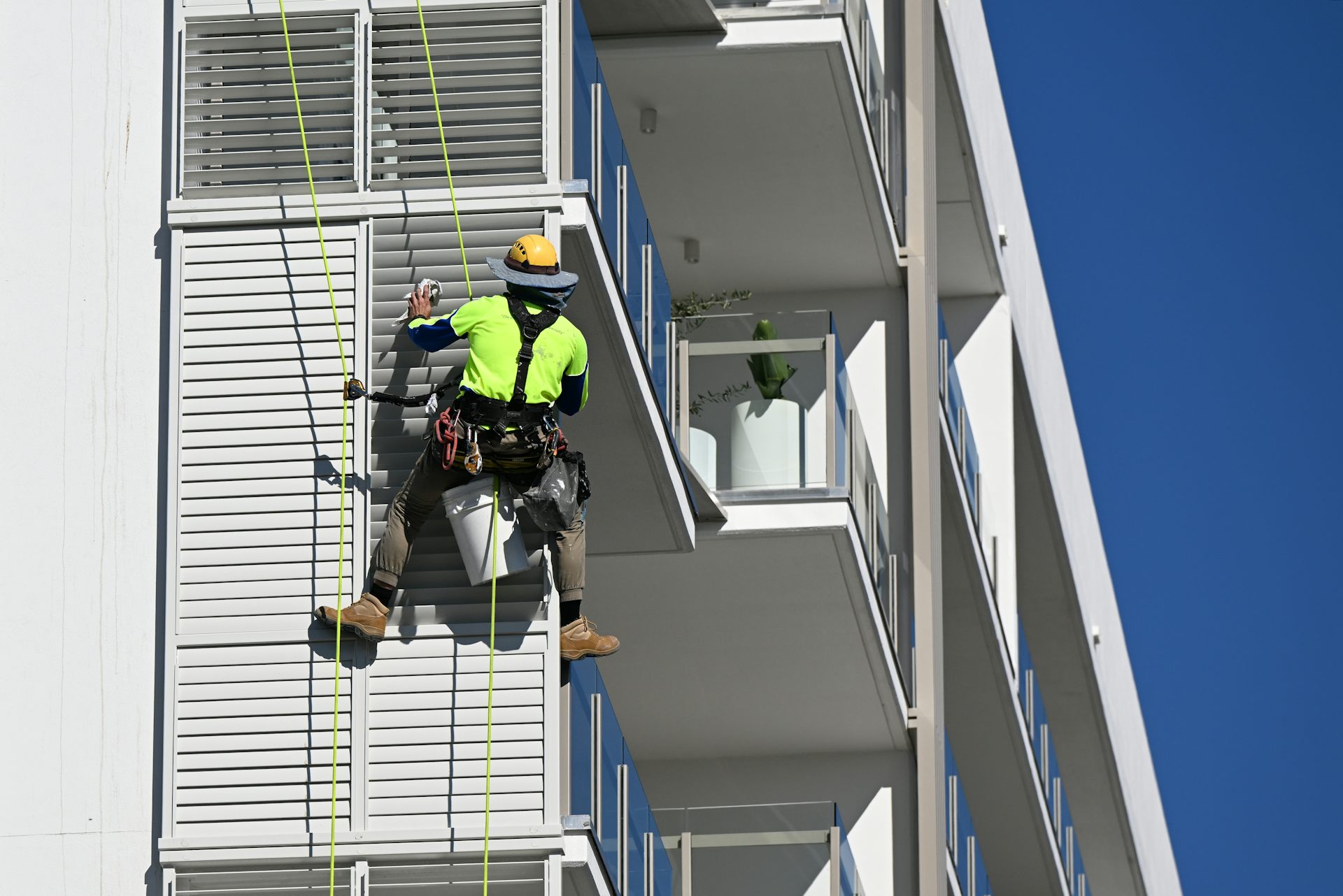 worker on white apartment building