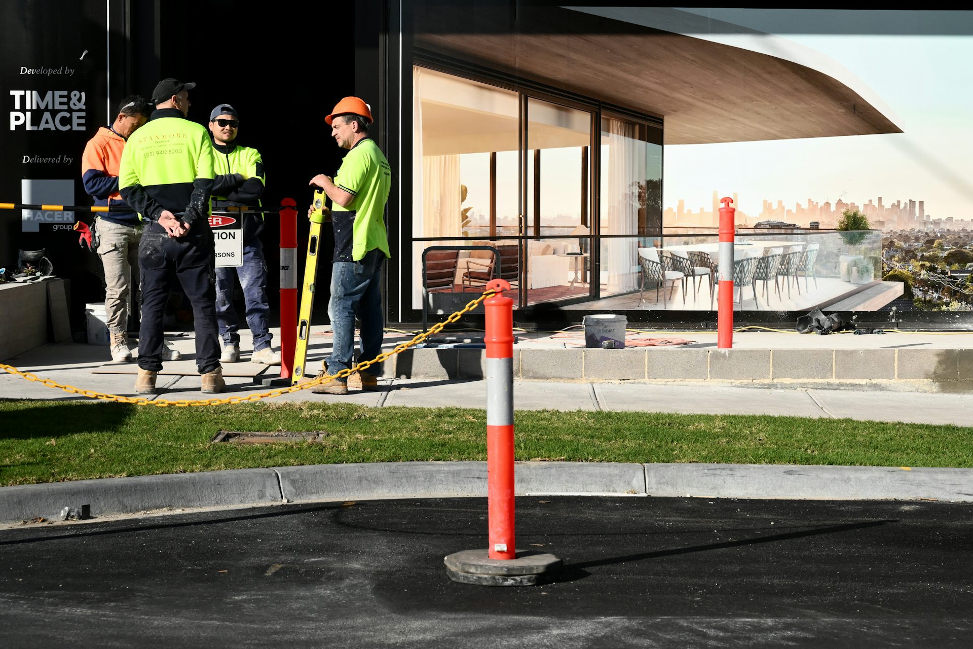 workers near new building with light-coloured path