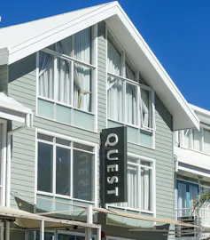 Exterior of a Quest hotel with signage