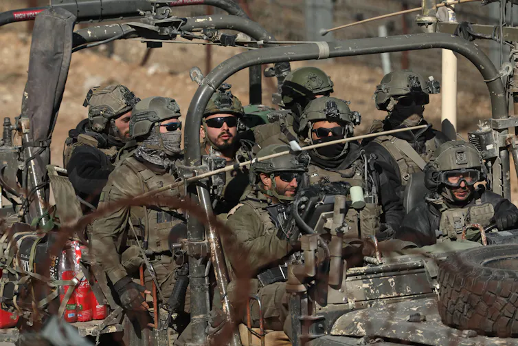 Israeli soldiers in a vehicle.
