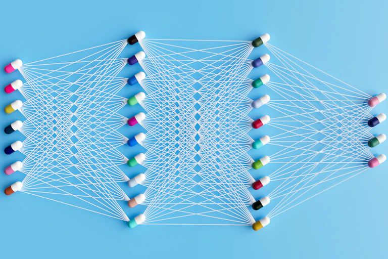 Four rows of pills with threads of white string connect them to each other in a geometric net
