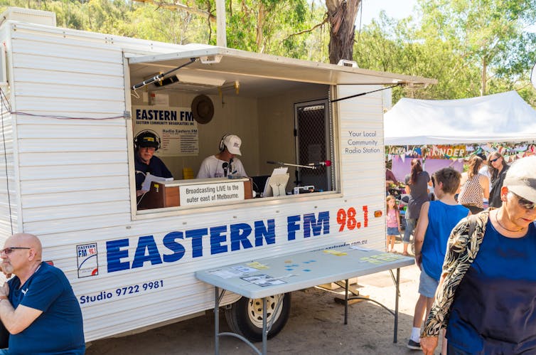 A white metal van for a community radio station