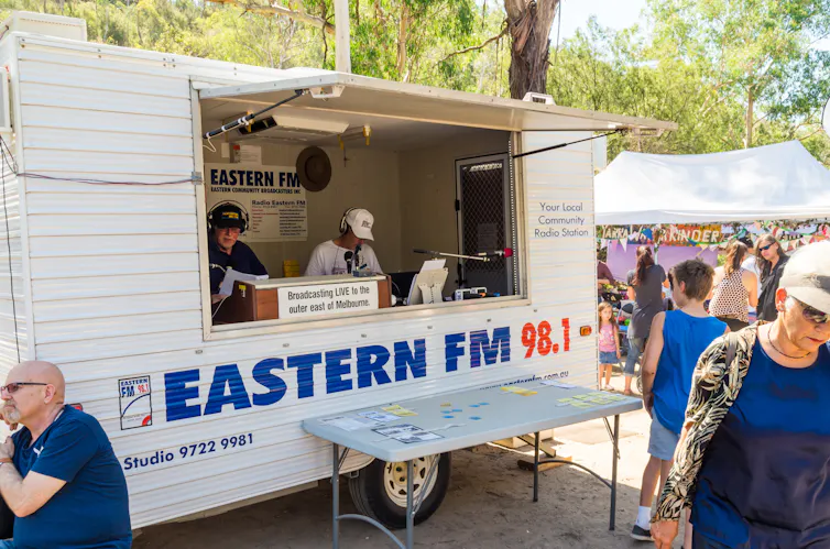 A white metal van for a community radio station