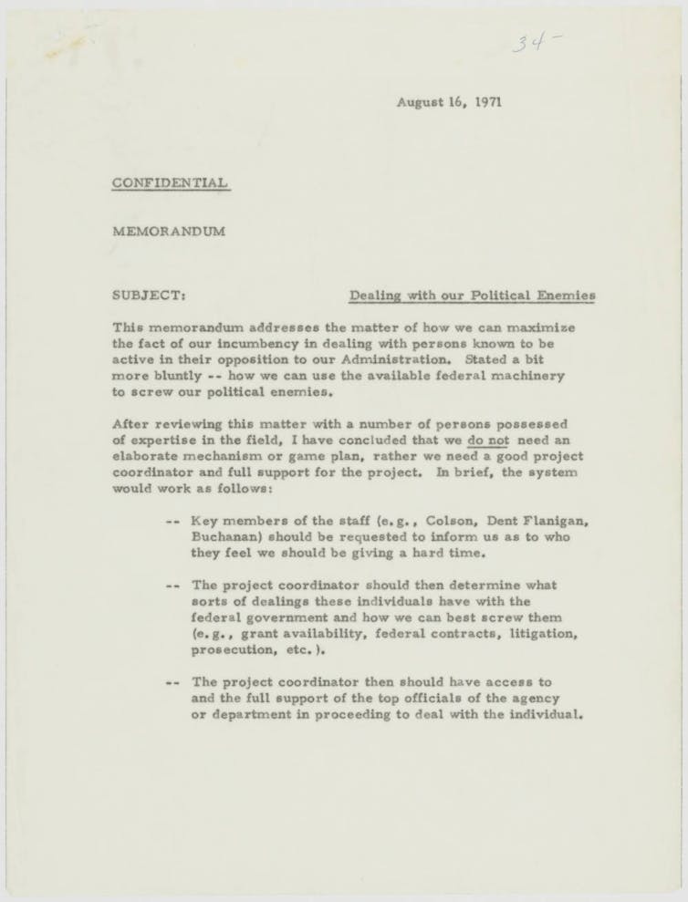 A beige piece of paper with typing on it that includes 'SUBJECT: Dealing with our Political Enemies.'