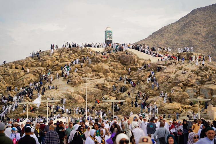 pilgrims climbing mount arafat hot day