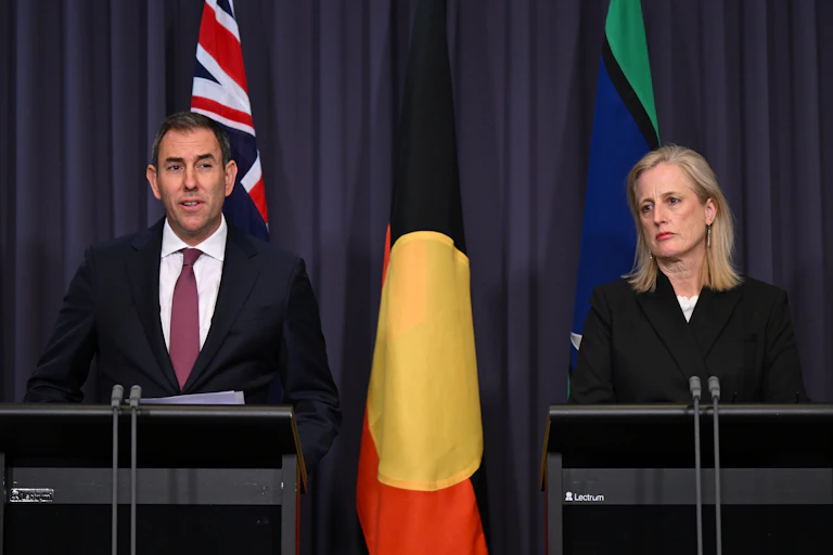Man and woman standing behind lecterns