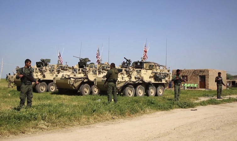 Kurdish fighters with US troops in Syria in 2017.