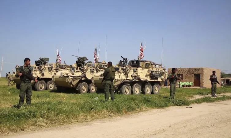 Kurdish fighters with US troops in Syria in 2017.