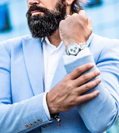 Man holding up arm showing expensive watch