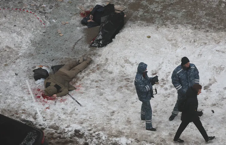 Russian security personnel with Kirillov's body after the shooting.