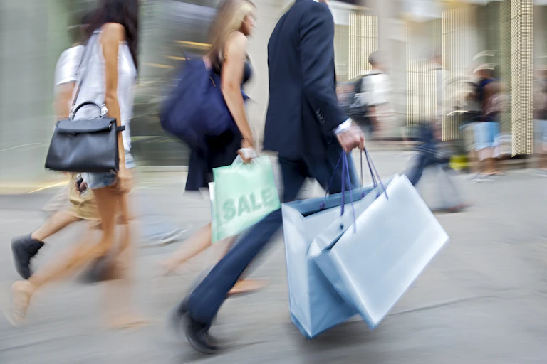 blurred shot of people shopping on a high street