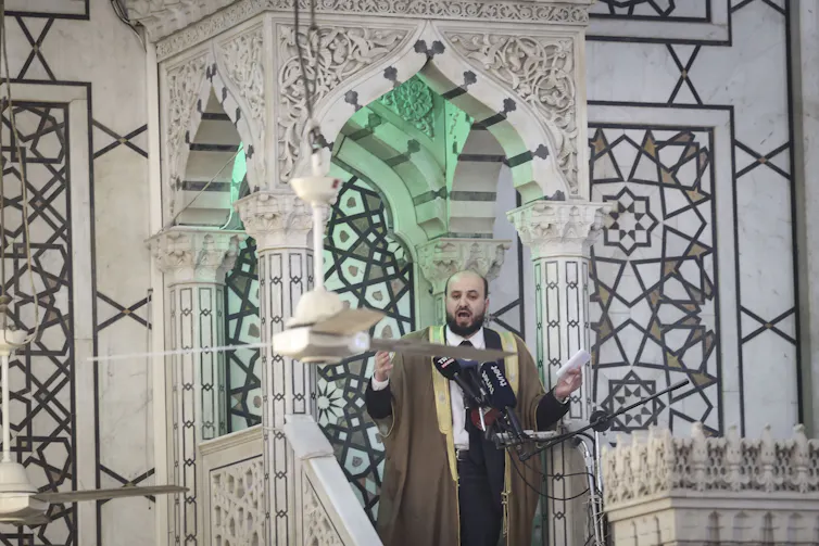 Mohammed al-Bashir delivering a speech in a mosque.