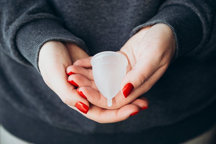 A clean menstrual cup is held in the hand.