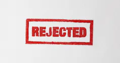 Red Rejected stamped on white paper