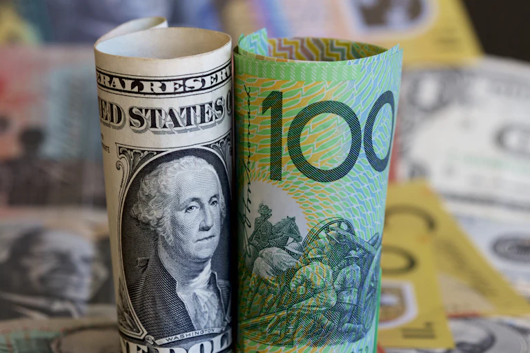 Rolled up Australian currency next to rolled up US currency
