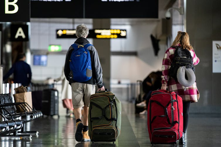 Travellers walk through an airport terminal in Melbourne