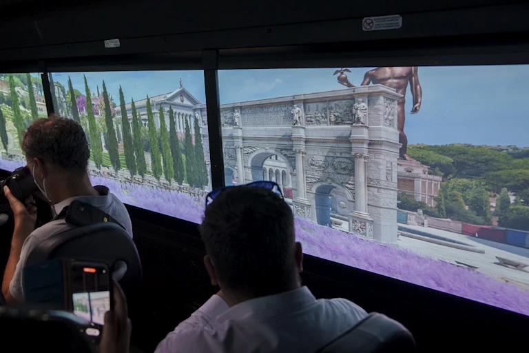 People looking at images of ancient buildings.