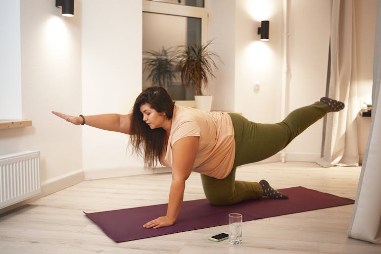 A woman exercises.