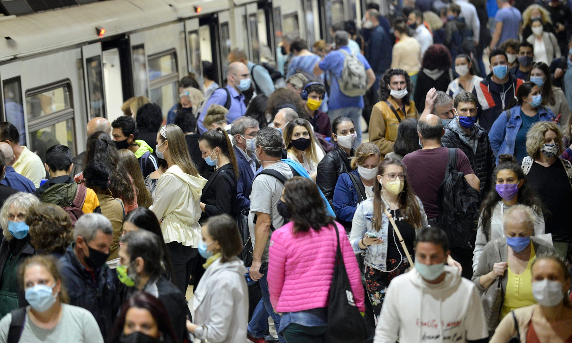 A crowd of masked people on a station platform in Sofia, Bulgaria.