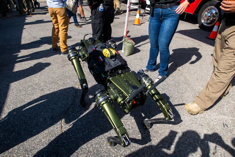 a robot dog surrounded by people