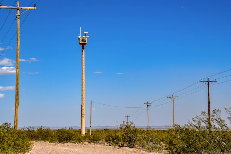 a pole with a camera mounted on top in the desert