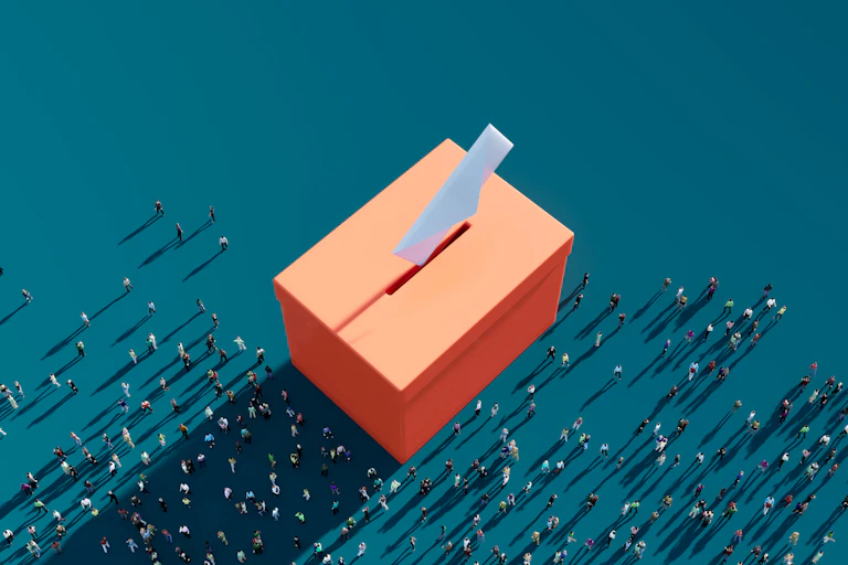 An image of orange ballot box is seen with drawings of men and women around it.