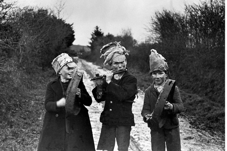 Black and white photo of three boys celebrating Wren's Day