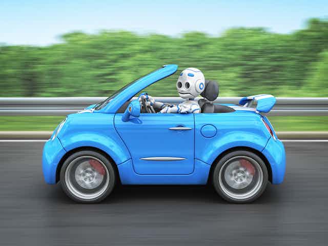 a robot drives a small convertible car on a road