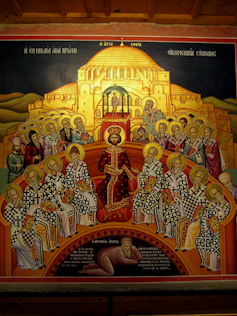 A jewel-toned religious painting of men with halos seated around a kingly figured in red robes, and one man in plainer clothes lying at the bottom.